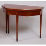 A Sheraton period mahogany, rosewood crossbanded and inlaid tea table, the fold-over top having