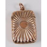 A small 9ct gold vesta case, having a sunburst type design, 7.2g, Birmingham 1915, 3.5cm