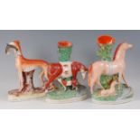 A large Victorian Staffordshire figure of a lurcher, in standing pose with rabbit in its jaws, on