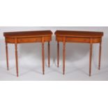 A pair of satinwood and crossbanded round cornered single drawer hall tables, each raised on slender