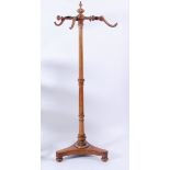 A Victorian figured walnut freestanding hat and coat stand, the half-fluted column supporting