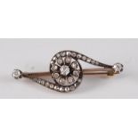 A late Victorian yellow and white metal diamond bar brooch in the form of a rotating flower, set