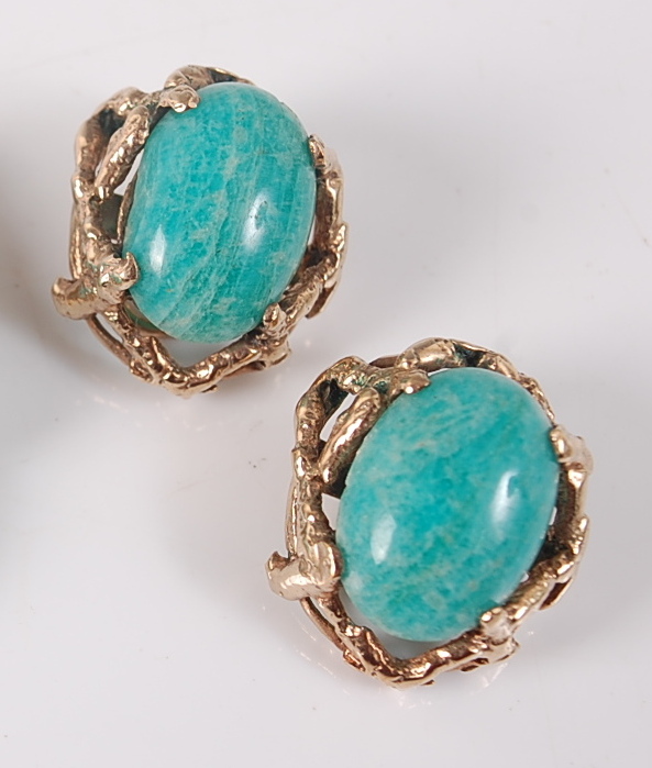 A pair of 9ct yellow gold abstract earrings, each featuring an oval dyed green cabochon stone within