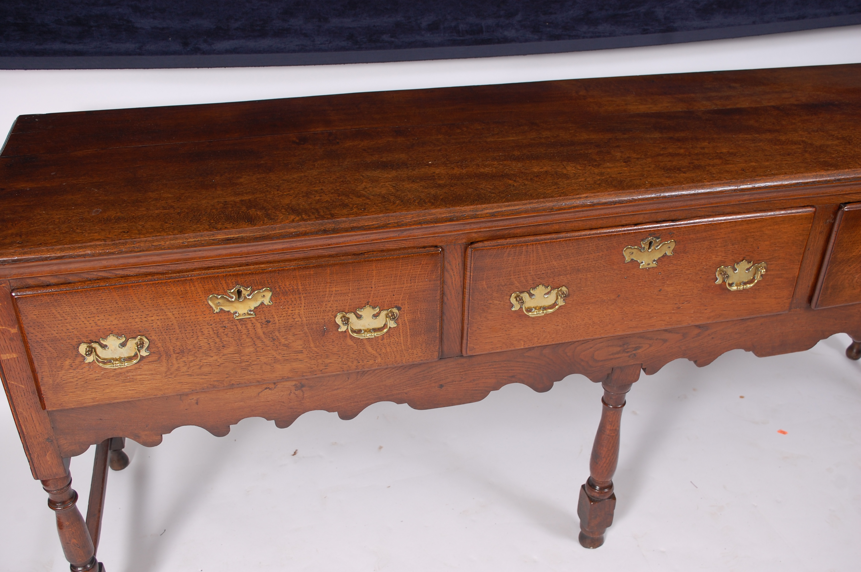 An oak dresser base in the Georgian style, having an arrangement of three frieze drawers with - Image 3 of 3