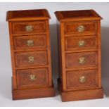 A pair of figured walnut cross and feather banded bedside chests, each fitted with four graduated