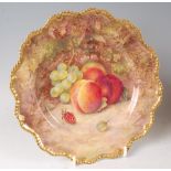 A Worcester porcelain cabinet plate, decorated with fruit on a mossy bank by R. Sebright, signed