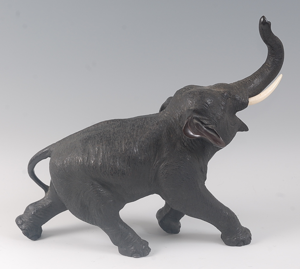 A Japanese Meiji period (1868-1912) bronze elephant, in striding pose, its trunk raised, all over - Image 3 of 4