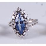 A white metal, sapphire and diamond marquise shaped cluster ring, featuring a centre marquise cut
