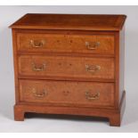 A Georgian style burr oak, crossbanded and further inlaid chest, of three long graduated drawers,