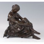 A late 19th century French bronze of a female musician, in seated pose with harp behind her, brown