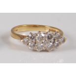 An 18ct yellow and white gold diamond marquise shaped cluster ring, featuring eleven round brilliant
