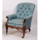 An early Victorian rosewood framed spoonback armchair, the whole upholstered in a silk blue