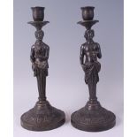 A pair of circa 1900 bronze figural candle holders, modelled as allegorical figural busts to