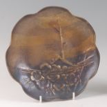 A Japanese Taisho Period (1912-26) hammered copper dish, the raised edge of lobed form, gilt and