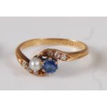 An early 20th century 18ct yellow gold, sapphire, pearl and diamond crossover ring, the round