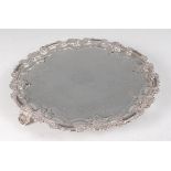 A George IV silver salver, having a leaf and shell carved piecrust rim, engraved ground with central