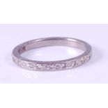 A white metal diamond half-hoop eternity ring, the twelve round brilliant cut diamonds each