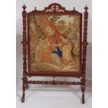An early Victorian mahogany and tapestry embroidered fire screen, the embroidery depicting classical