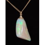 A polished opal pendant, weighing approx 25 carats and measuring approx 60 x 17 x 12mm, on