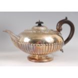 A William IV silver teapot, of half-reeded squat circular form, having ebony handle, 24.5oz, maker