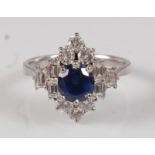 A white metal, sapphire and diamond marquise shaped cluster ring, featuring a centre oval faceted