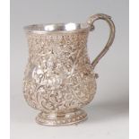 A late 19th century Indian silver baluster tankard, having all-over scroll flower and foliage chased