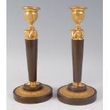 A pair of late 19th century French Egyptian Revival bronze and gilt bronze candleholders, as