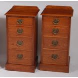 A pair of oak ledgeback bedside chests, each fitted with four graduated drawers, with heart shaped