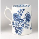 A Lowestoft porcelain mug, circa 1770, underglaze blue decorated with floral prints and butterflies,