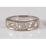 A white metal diamond half hoop eternity ring, featuring six round brilliant cut diamonds in