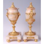 A pair of late 19th century French gilt bronze and onyx pedestal garniture urns and covers, the