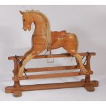 A contemporary pitched pine childs' rocking horse by Stevenson Brothers, model No.076, having