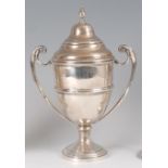 A George V silver pedestal twin handled cup and cover, 16.3oz, maker John Taylor & Company,