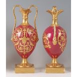 A pair of 19th century hard-paste porcelain vases, of baluster form, with slender gilded necks,