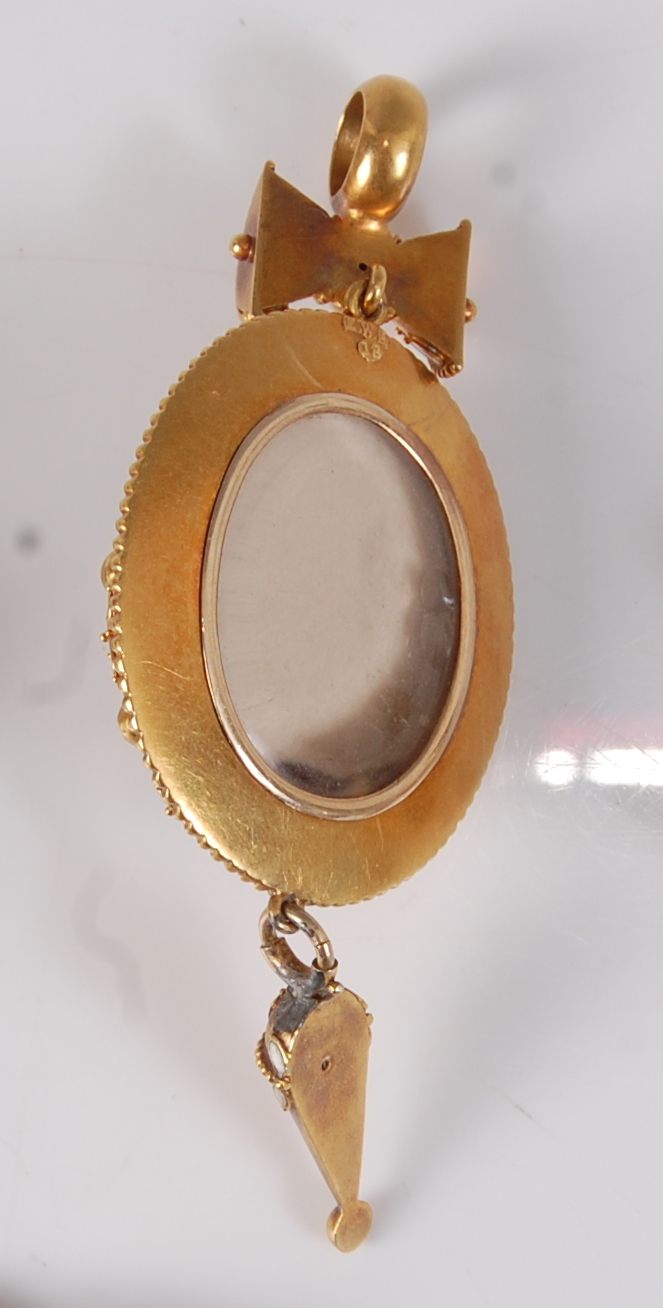 A late Victorian yellow metal target style mourning pendant, featuring a centre black hardstone - Image 2 of 2