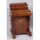 A mid-Victorian figured walnut piano top davenport, the fret carved three-quarter gallery