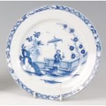 A Lowestoft porcelain plate, circa 1765, underglaze blue decorated in the Lady & Parasol pattern
