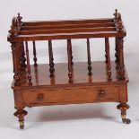 A mid-Victorian figured walnut three-division music canterbury, having end carry handles and
