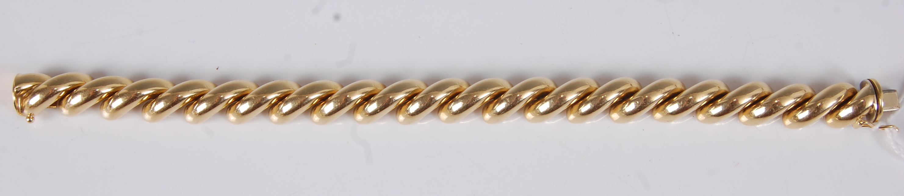 An 18ct yellow gold diagonal curved bar bracelet, with box clasp and figure of eight safety catch, - Image 2 of 2