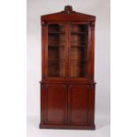 A William IV mahogany bookcase cabinet, having a glazed upper section, the twin square cut pilasters