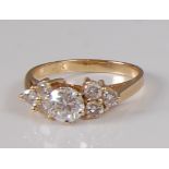 A 14ct gold diamond ring, the centre claw set round brilliant weighing approx 0.7 carats, flanked to