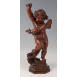 A 19th century continental polished walnut carving modelled as a standing putti, with right arm