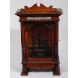 A late 19th century Nicole Frères if Liepzig walnut cased upright polyphon, being coin operated,