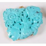 A yellow metal abstract turquoise pendant, comprising a carved floral panel within a scroll work