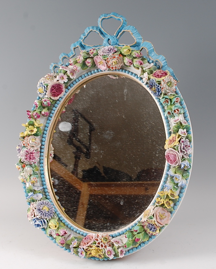 A 19th century Meissen porcelain easel dressing table mirror, the circular plate with ribbon