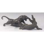 A Japanese Meiji period (1868-1912) bronze group of a tiger attacking a crocodile, each in roaring
