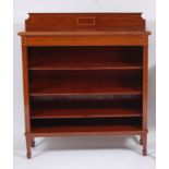 An Edwardian mahogany and satinwood inlaid ledgeback freestanding open bookshelf, having three