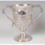 A late Georgian silver pedestal loving cup, the whole later chased with grazing livestock amidst