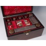 A Victorian rosewood toilet / vanity box, the mother of pearl inlaid hinged cover opening to