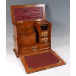 A Victorian oak stationery cabinet, with cut brass mounts, the hinged cover and fall-front opening